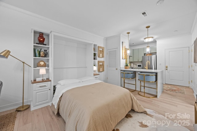 630 Calvert St Unit 111, Charlotte, NC 28208 - bedroom with ornamental molding, freestanding refrigerator, and light wood-type flooring