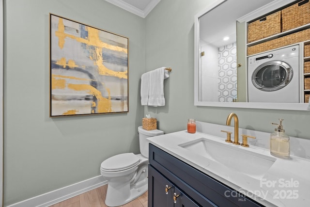 630 Calvert St Unit 111, Charlotte, NC 28208 - full bathroom featuring washer / dryer, ornamental molding, baseboards, vanity, and toilet
