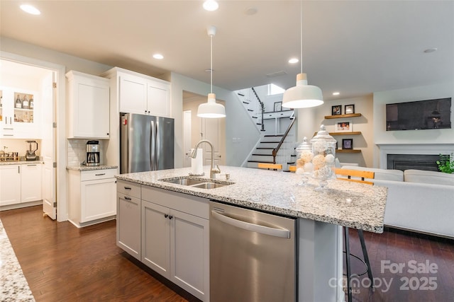 5130 Watersail Way, Clover, SC 29710 - kitchen featuring appliances with stainless steel finishes, a sink, open floor plan, an island with sink, and white cabinets