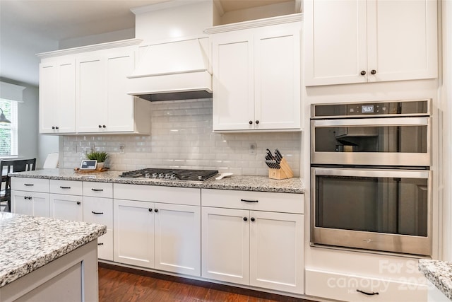 5130 Watersail Way, Clover, SC 29710 - kitchen with stainless steel appliances, white cabinetry, decorative backsplash, and light stone counters