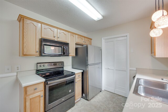 110 Eighth St, York, SC 29745 - kitchen with stainless steel appliances, light brown cabinetry, light countertops, and a textured ceiling