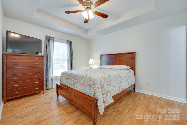 110 Eighth St, York, SC 29745 - bedroom featuring a tray ceiling, light wood-style floors, baseboards, and ceiling fan