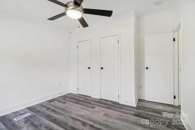 2315 Circle Dr, Great Falls, SC 29055 - unfurnished bedroom featuring dark wood-style floors, a ceiling fan, and baseboards
