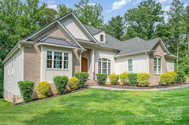 10874 Rise Ln, Fort Mill, SC 29707 - view of front of property featuring board and batten siding, a front lawn, brick siding, and a shingled roof