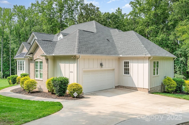 10874 Rise Ln, Fort Mill, SC 29707 - view of front facade featuring roof with shingles, a garage, concrete driveway, and view of wooded area