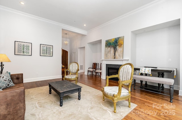 10874 Rise Ln, Fort Mill, SC 29707 - living area with crown molding, wood finished floors, a glass covered fireplace, baseboards, and recessed lighting