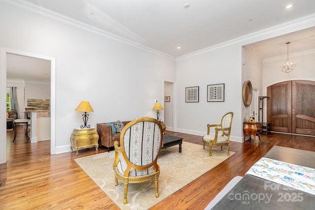 10874 Rise Ln, Fort Mill, SC 29707 - living area featuring arched walkways, wood finished floors, crown molding, baseboards, and a chandelier
