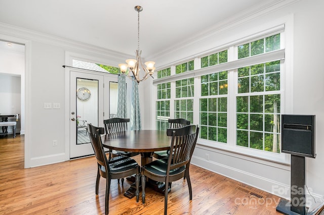 10874 Rise Ln, Fort Mill, SC 29707 - dining space featuring a chandelier, healthy amount of natural light, baseboards, ornamental molding, and light wood finished floors