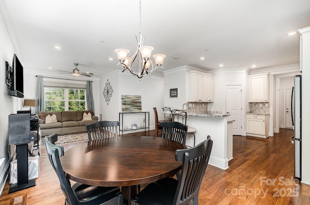 10874 Rise Ln, Fort Mill, SC 29707 - dining space with ceiling fan, ornamental molding, recessed lighting, wood finished floors, and a chandelier