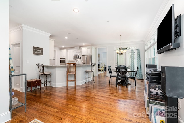 10874 Rise Ln, Fort Mill, SC 29707 - dining space featuring a chandelier, light wood finished floors, recessed lighting, ornamental molding, and baseboards