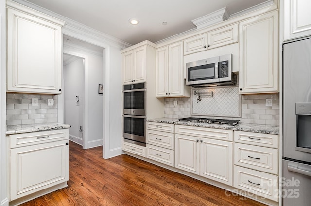 10874 Rise Ln, Fort Mill, SC 29707 - kitchen featuring stainless steel appliances, baseboards, tasteful backsplash, ornamental molding, and light stone countertops