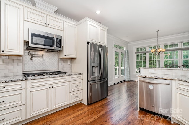 10874 Rise Ln, Fort Mill, SC 29707 - kitchen featuring appliances with stainless steel finishes, crown molding, tasteful backsplash, dark wood finished floors, and a chandelier