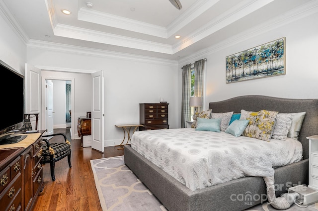 10874 Rise Ln, Fort Mill, SC 29707 - bedroom featuring wood finished floors, a tray ceiling, crown molding, recessed lighting, and baseboards