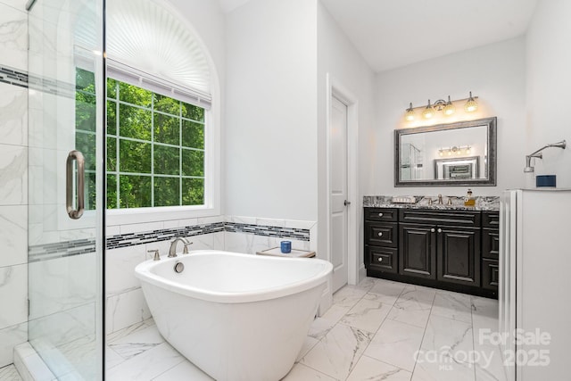 10874 Rise Ln, Fort Mill, SC 29707 - full bathroom featuring marble look tile flooring, a stall shower, a freestanding bath, vanity, and tile walls