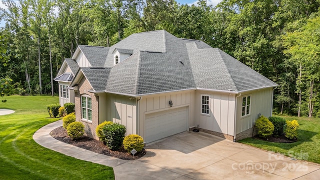10874 Rise Ln, Fort Mill, SC 29707 - view of front of property featuring a shingled roof, board and batten siding, a front yard, and an attached garage