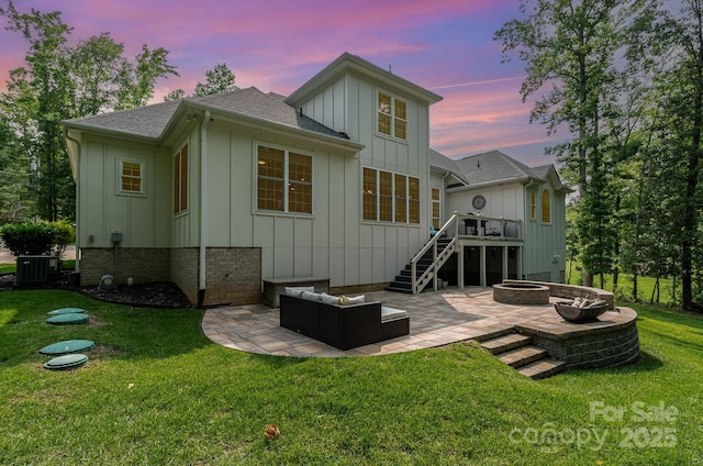 10874 Rise Ln, Fort Mill, SC 29707 - back of house at dusk with board and batten siding, a patio, and stairway