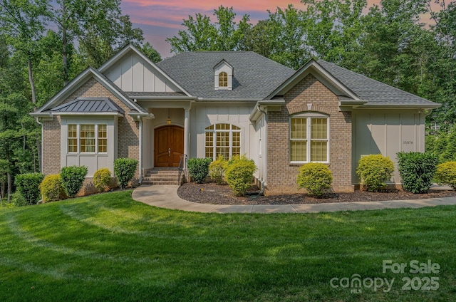 10874 Rise Ln, Fort Mill, SC 29707 - view of front of home with brick siding, a yard, and a shingled roof