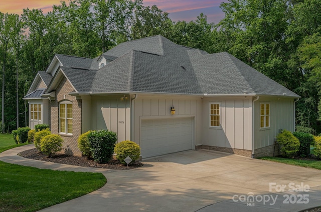 10874 Rise Ln, Fort Mill, SC 29707 - view of front of home with roof with shingles, an attached garage, driveway, and view of scattered trees