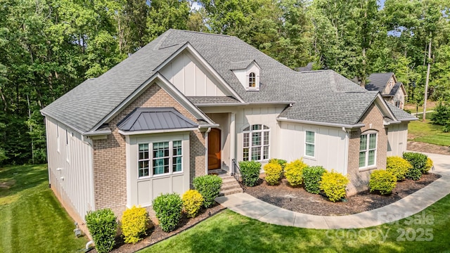 10874 Rise Ln, Fort Mill, SC 29707 - view of front of home with brick siding, board and batten siding, a front lawn, and a shingled roof