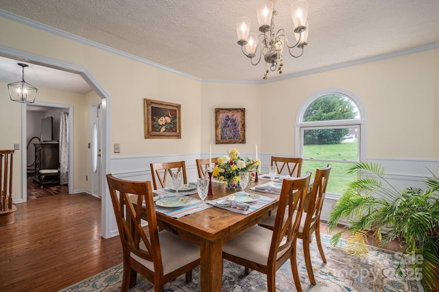 112 Ocean Dr, Shelby, NC 28152 - dining space with a chandelier, wood finished floors, a wainscoted wall, arched walkways, and ornamental molding