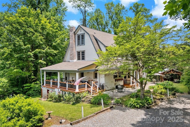 147 Preservation Way, Waynesville, NC 28786 - view of front facade featuring a chimney, a shingled roof, a porch, a patio, and stucco siding