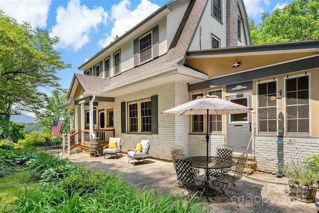 147 Preservation Way, Waynesville, NC 28786 - back of house with a patio, a shingled roof, and brick siding