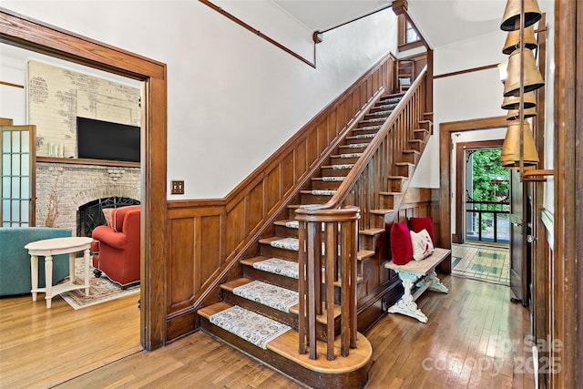 147 Preservation Way, Waynesville, NC 28786 - staircase featuring wood-type flooring, wainscoting, and a fireplace
