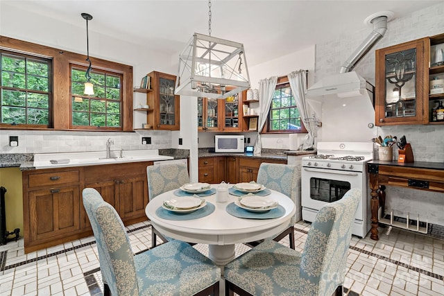 147 Preservation Way, Waynesville, NC 28786 - kitchen featuring open shelves, white appliances, brown cabinetry, and decorative backsplash