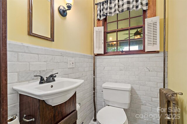 147 Preservation Way, Waynesville, NC 28786 - half bath with vanity, toilet, wainscoting, tile walls, and radiator