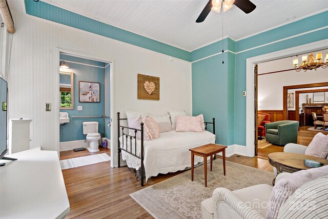 147 Preservation Way, Waynesville, NC 28786 - bedroom featuring wood finished floors, a chandelier, ornamental molding, connected bathroom, and baseboards