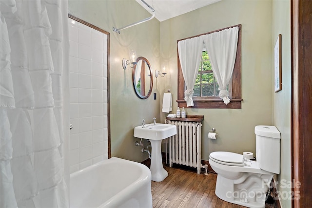 147 Preservation Way, Waynesville, NC 28786 - full bathroom with radiator heating unit, toilet, wood finished floors, and shower / bath combination with curtain