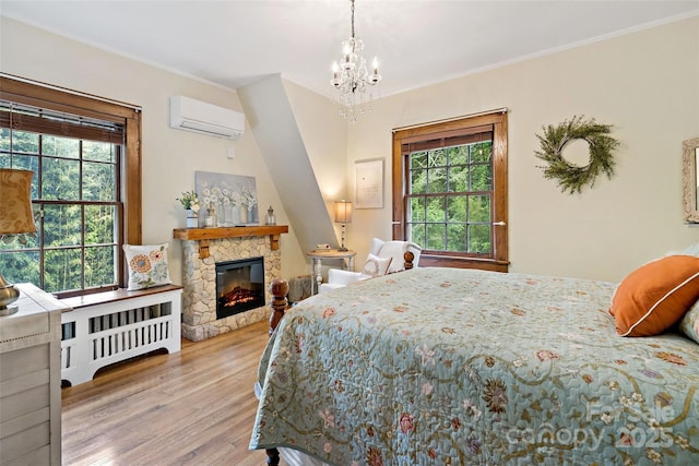 147 Preservation Way, Waynesville, NC 28786 - bedroom with an AC wall unit, multiple windows, wood finished floors, a chandelier, and ornamental molding