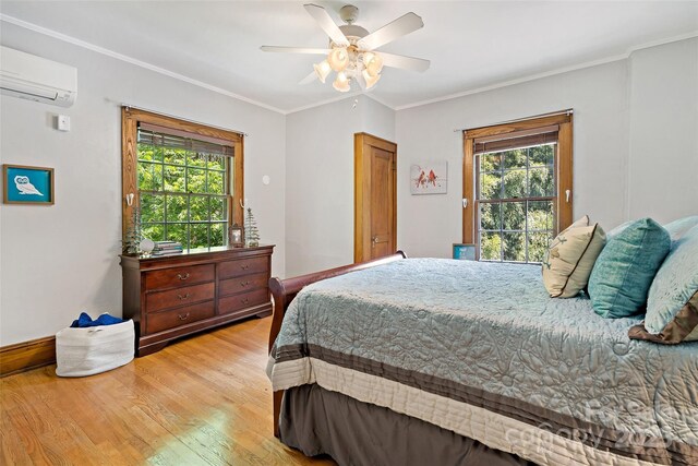 147 Preservation Way, Waynesville, NC 28786 - bedroom with a wall mounted air conditioner, light wood-style flooring, crown molding, and ceiling fan