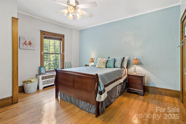 147 Preservation Way, Waynesville, NC 28786 - bedroom with radiator heating unit, light wood-style floors, baseboards, ornamental molding, and a ceiling fan