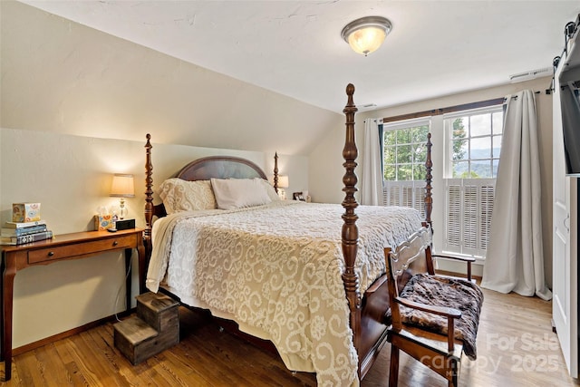 147 Preservation Way, Waynesville, NC 28786 - bedroom featuring wood finished floors, vaulted ceiling, and baseboards
