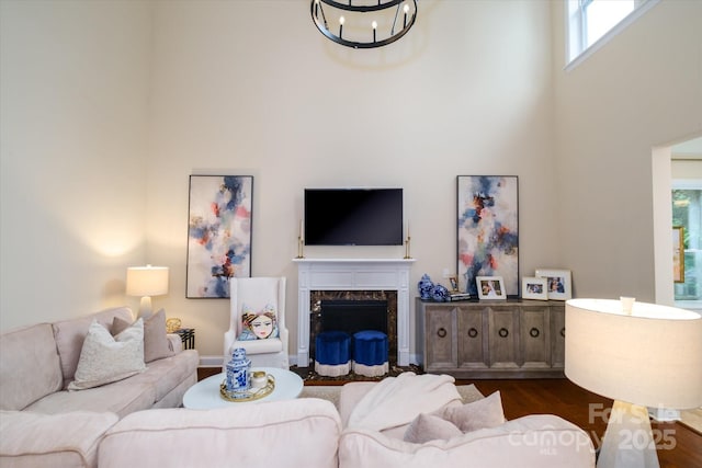 4323 Bright Rd, Charlotte, NC 28214 - living area with a towering ceiling, a chandelier, dark wood-style floors, and a premium fireplace