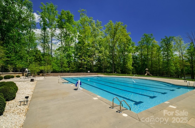 4323 Bright Rd, Charlotte, NC 28214 - community pool featuring a patio and view of wooded area