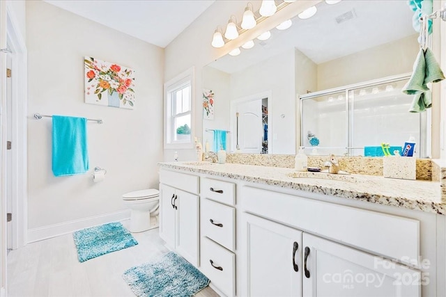 620 River Birch Dr, Salisbury, NC 28146 - full bathroom featuring baseboards, double vanity, a stall shower, and toilet