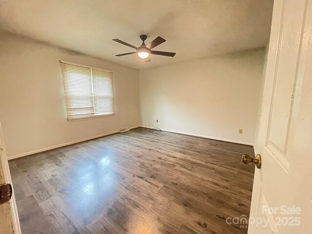 4317 Waxhaw Indian Trail Rd, Indian Trail, NC 28079 - spare room with dark wood-style flooring, ceiling fan, and baseboards
