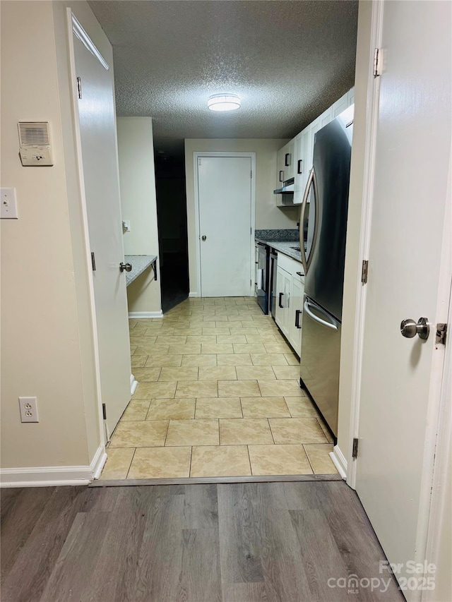9541 Shannon Green Dr Unit C, Charlotte, NC 28213 - corridor featuring a textured ceiling, light wood-type flooring, and baseboards