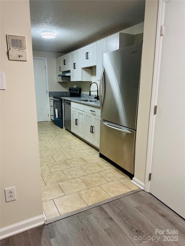 9541 Shannon Green Dr Unit C, Charlotte, NC 28213 - kitchen with freestanding refrigerator, range, a sink, under cabinet range hood, and white cabinets