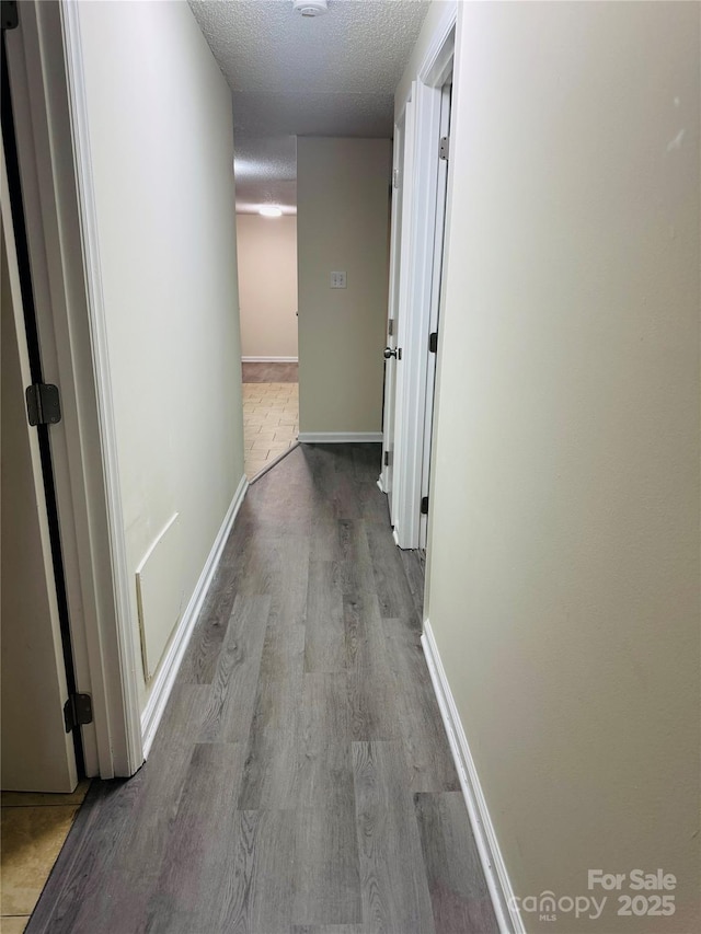 9541 Shannon Green Dr Unit C, Charlotte, NC 28213 - hall featuring a textured ceiling, wood finished floors, and baseboards