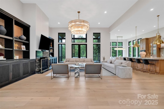 38 Thistle Ln, Fletcher, NC 28732 - living room with light wood-style floors, a premium fireplace, a chandelier, and recessed lighting