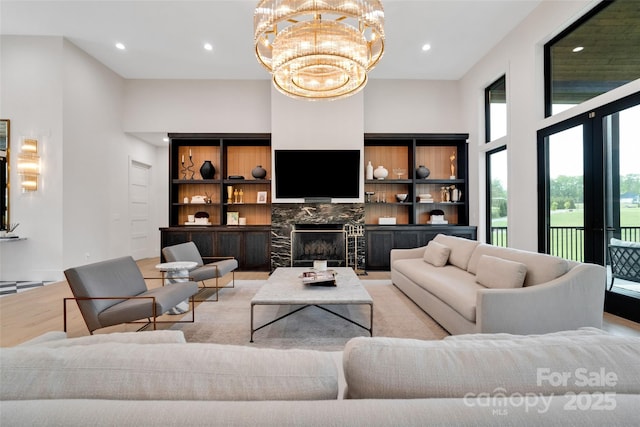 38 Thistle Ln, Fletcher, NC 28732 - living room with wood finished floors, a chandelier, recessed lighting, and a fireplace