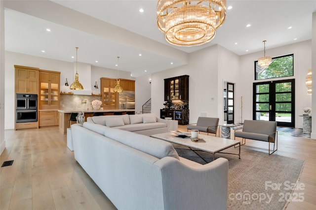 38 Thistle Ln, Fletcher, NC 28732 - living area featuring stairs, recessed lighting, light wood finished floors, a chandelier, and a towering ceiling