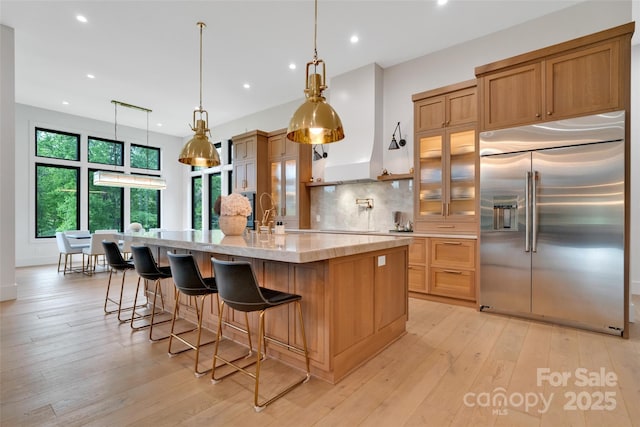 38 Thistle Ln, Fletcher, NC 28732 - kitchen featuring built in refrigerator, recessed lighting, decorative backsplash, a large island with sink, and light wood-style flooring