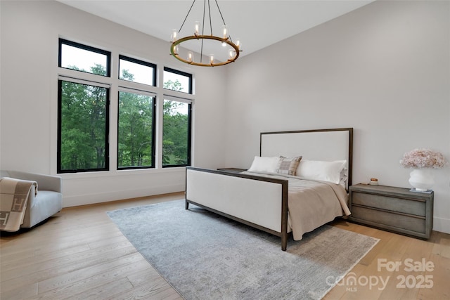 38 Thistle Ln, Fletcher, NC 28732 - bedroom with a chandelier, wood finished floors, and baseboards