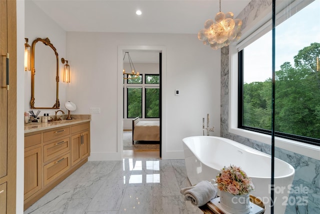 38 Thistle Ln, Fletcher, NC 28732 - bathroom featuring a chandelier, vanity, marble tiled floors, a freestanding tub, and recessed lighting