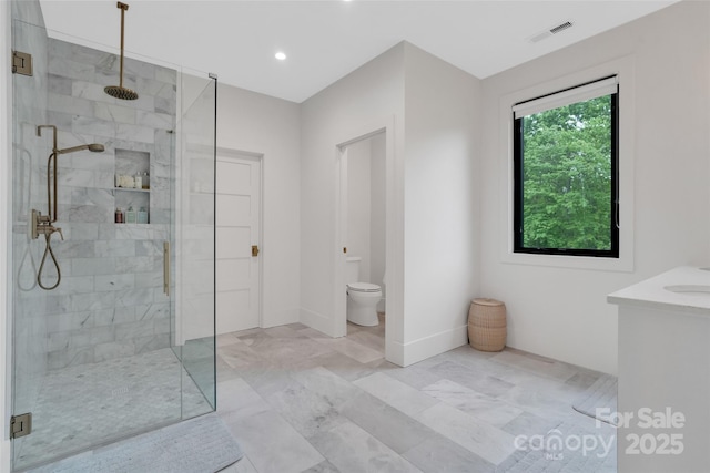 38 Thistle Ln, Fletcher, NC 28732 - bathroom with a shower stall, toilet, vanity, marble look tile flooring, and recessed lighting