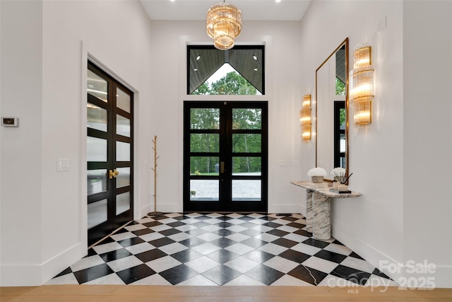38 Thistle Ln, Fletcher, NC 28732 - entrance foyer with french doors, plenty of natural light, a towering ceiling, baseboards, and a chandelier